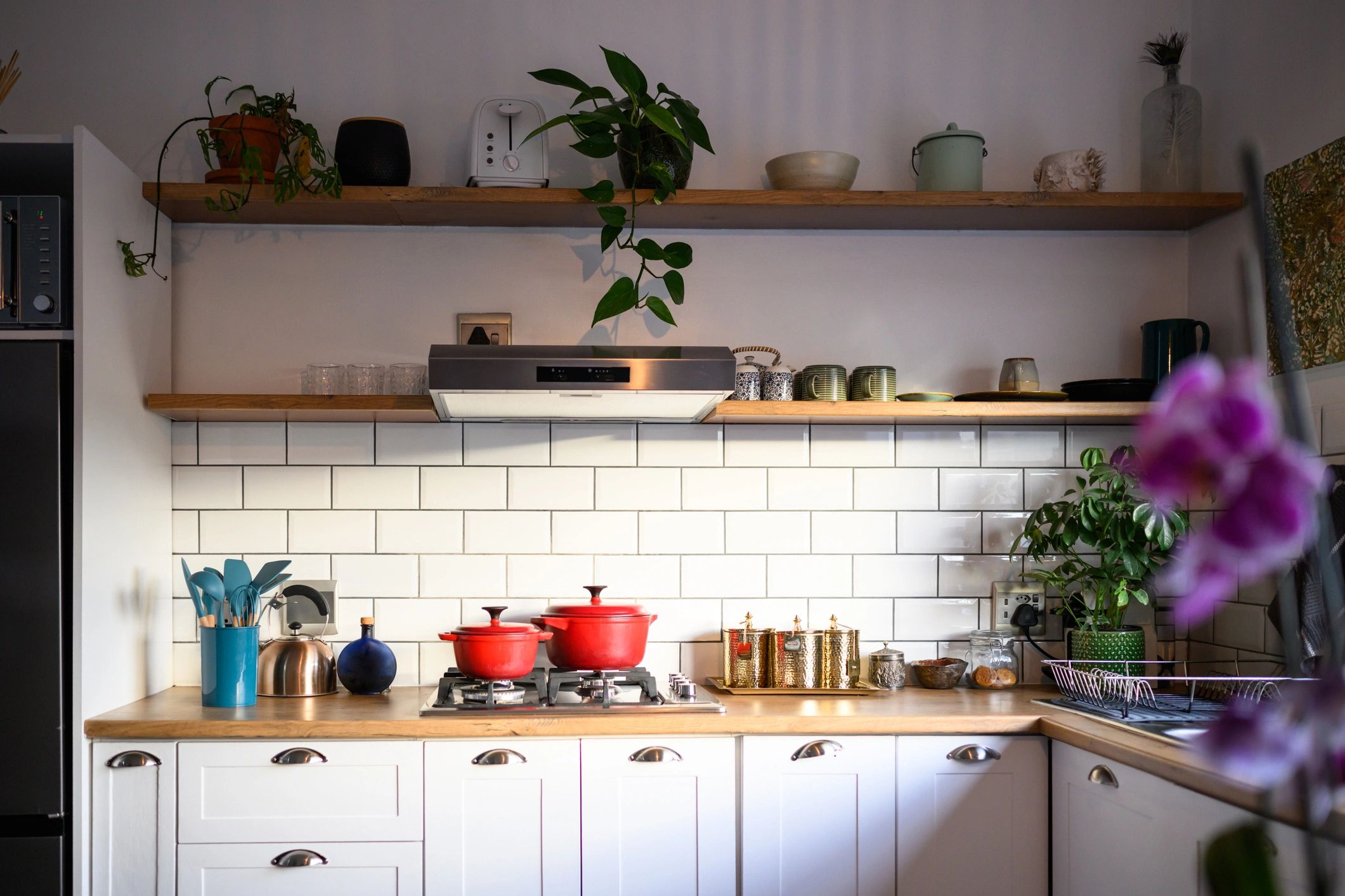 Bright fitted kitchen showcasing bespoke cabinetry