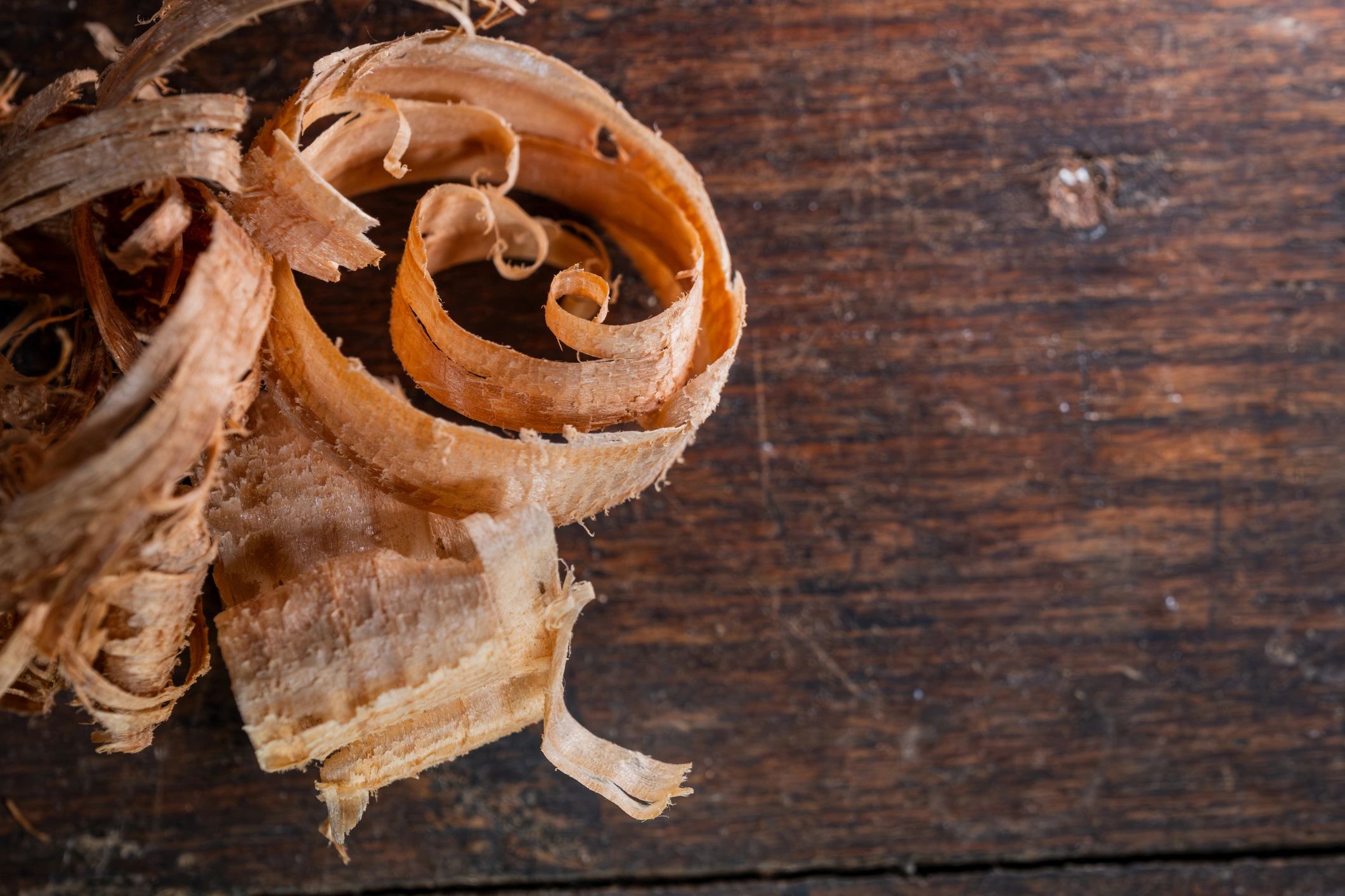 Natural wood shavings representing fine craftsmanship
